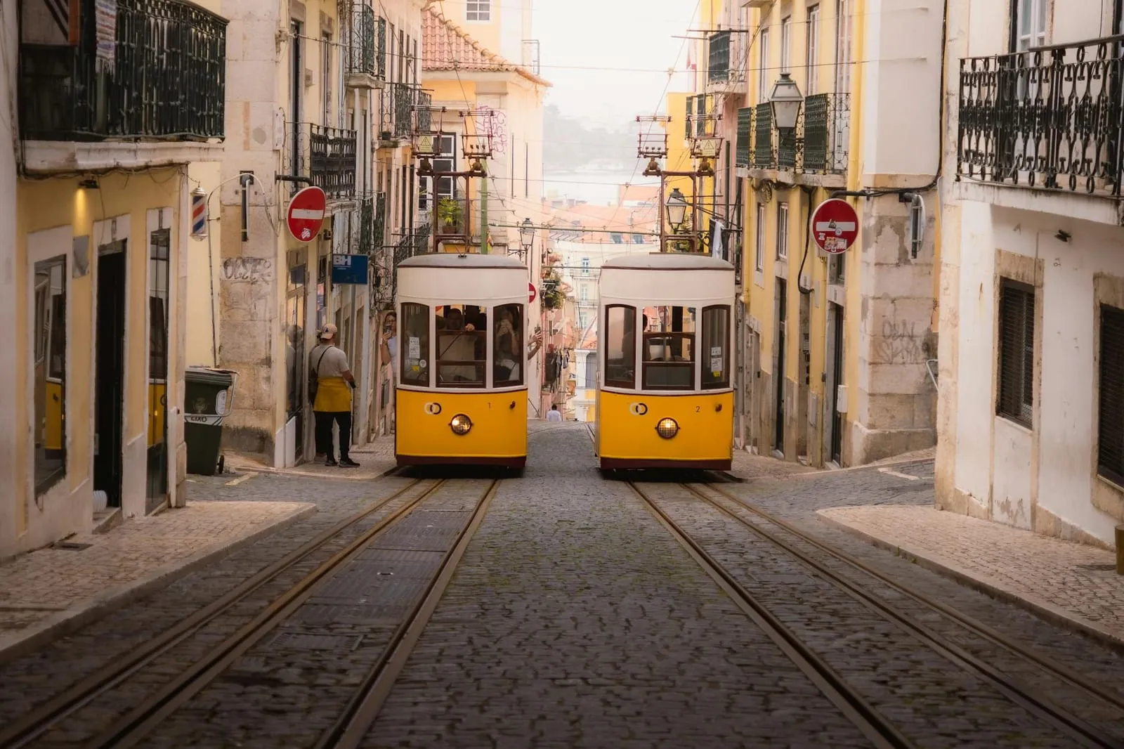 Eléctrico amarelo de Lisboa numa rua de dia de sol
